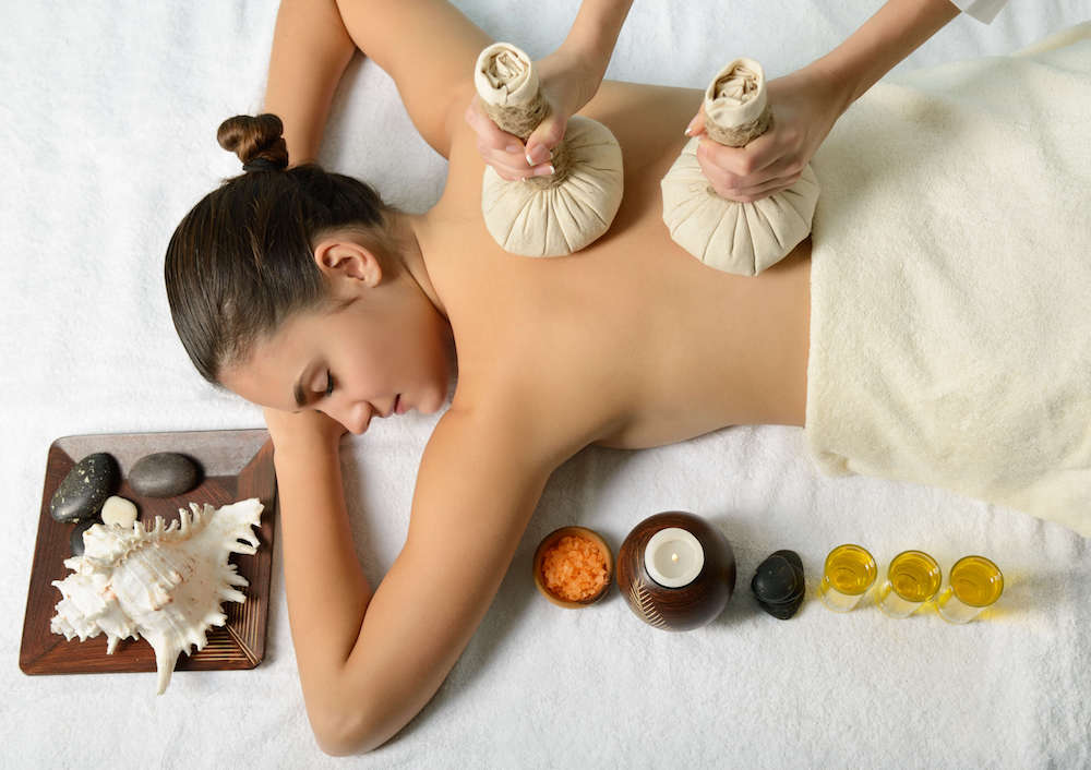 Deep tissue herbal Thai massage with compresses